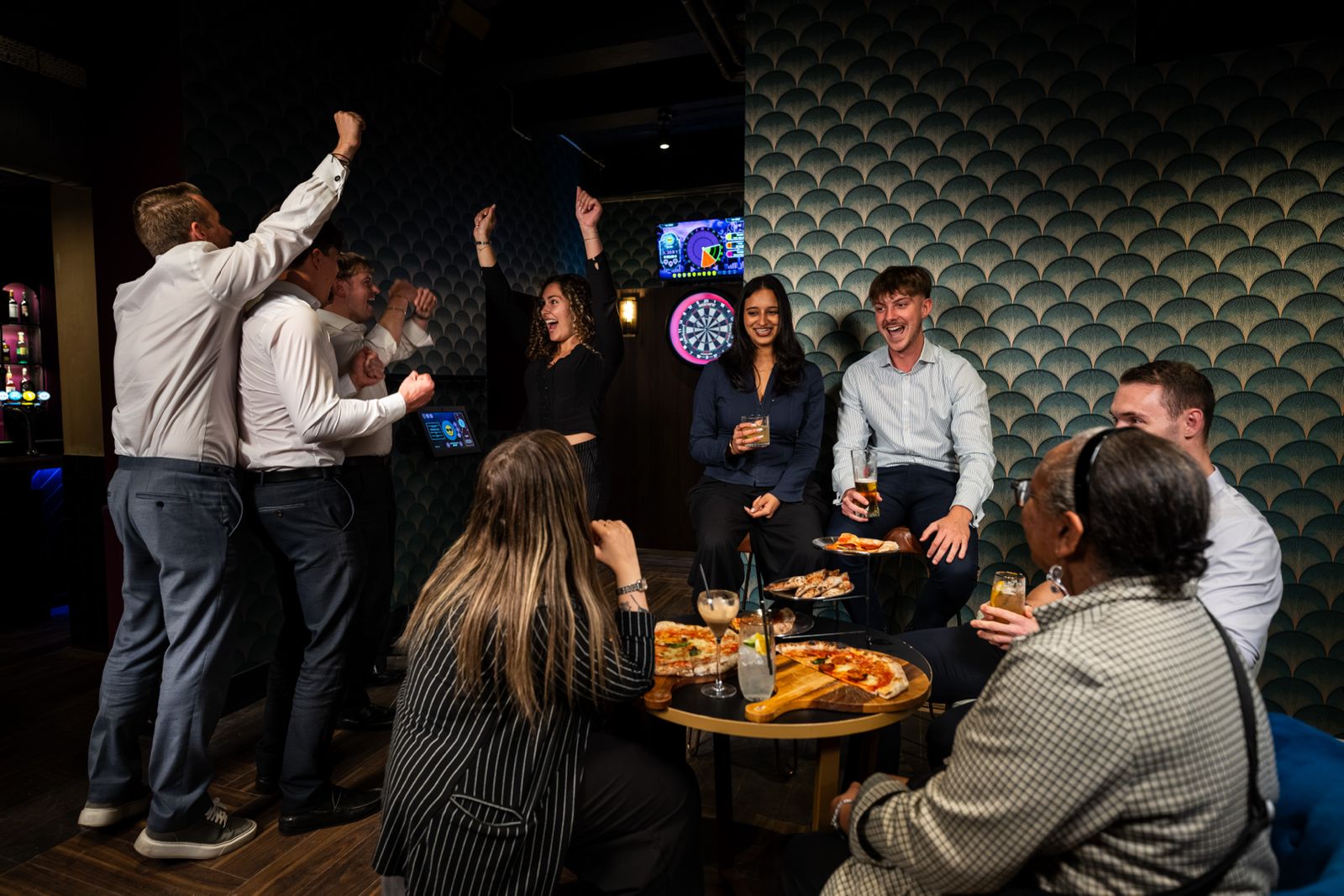 The main room at Annie's Room, lit for the evening, with a game on the lane screen